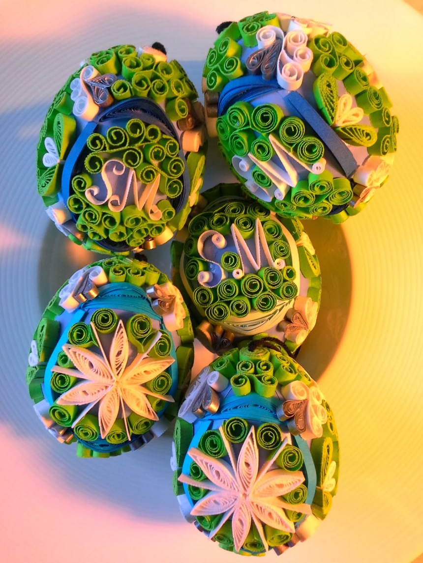 Blown eggs decorated in filigree quilling; green, blue, white and silver paper of various weights